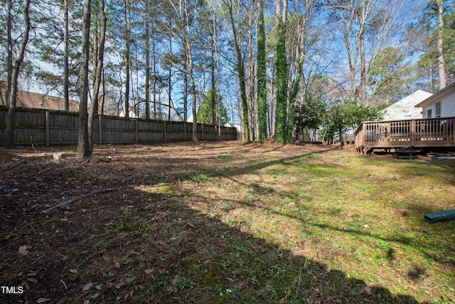 view of yard featuring a wooden deck and fence