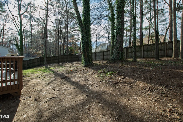 view of yard featuring a fenced backyard and a wooden deck