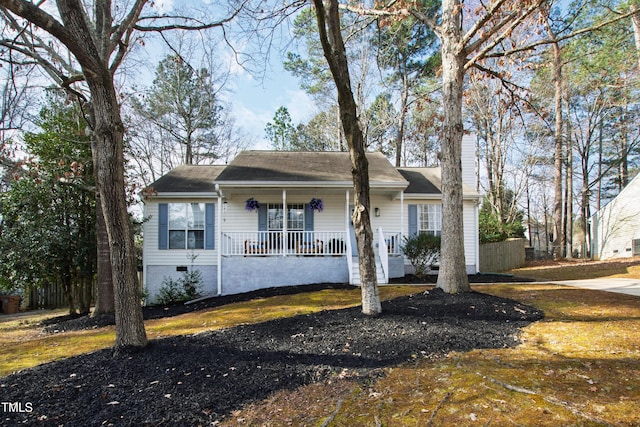 view of front facade featuring crawl space, a porch, and a chimney