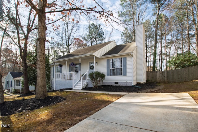 ranch-style home with a chimney, fence, covered porch, and crawl space