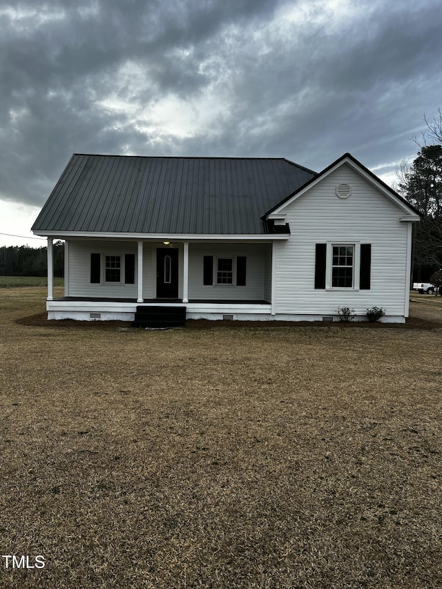 view of front facade with a porch, metal roof, and crawl space