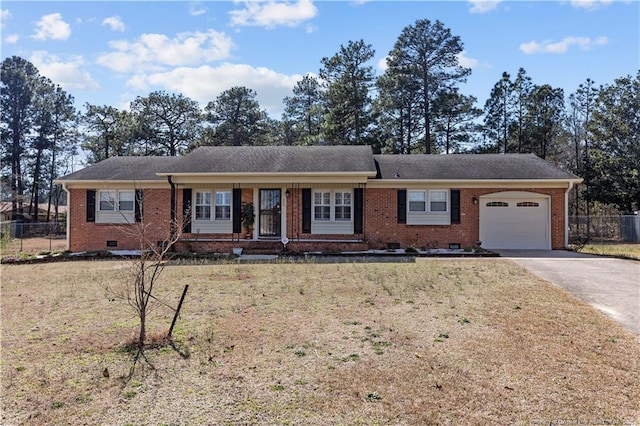 ranch-style home featuring brick siding, fence, a front yard, crawl space, and driveway