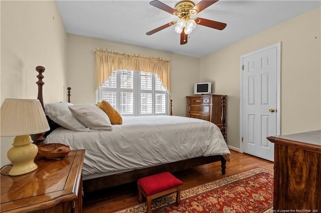 bedroom with wood finished floors and ceiling fan