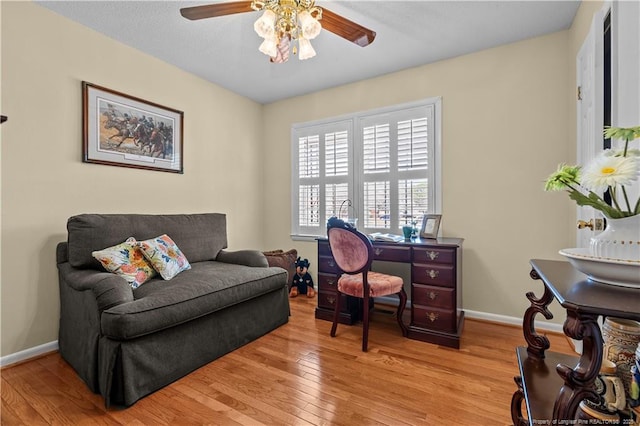 office space with ceiling fan, baseboards, and light wood-style flooring