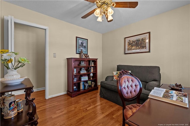 office featuring a ceiling fan, wood finished floors, and baseboards