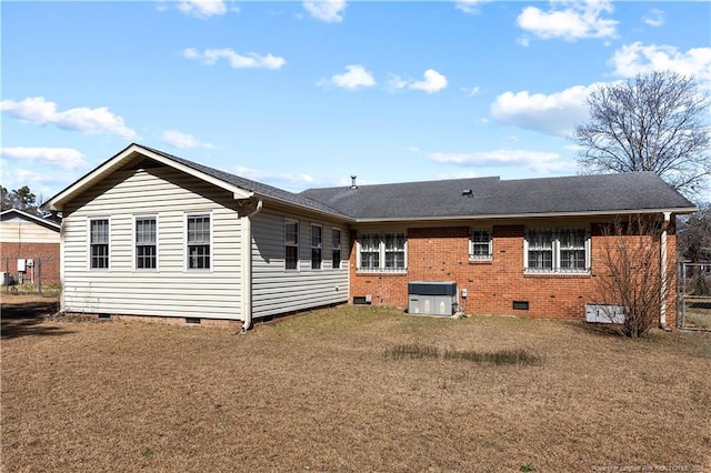 back of house featuring cooling unit, fence, a yard, crawl space, and brick siding