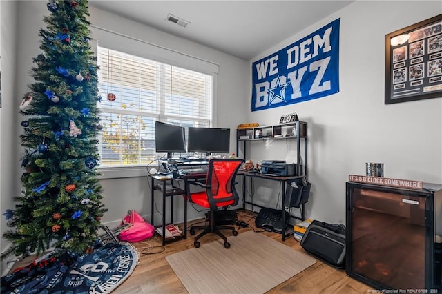 office area with wood finished floors and visible vents