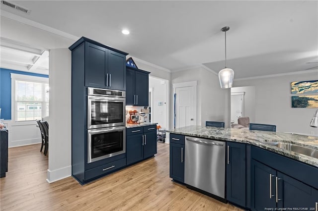 kitchen featuring visible vents, a sink, blue cabinetry, coffered ceiling, and appliances with stainless steel finishes