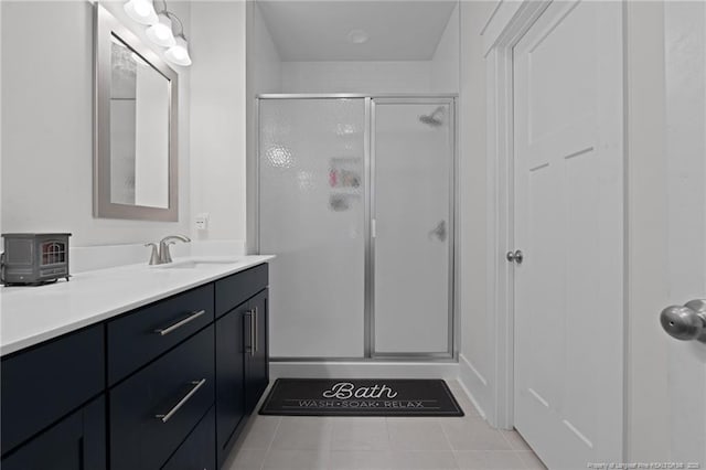 bathroom with a stall shower, vanity, and tile patterned flooring