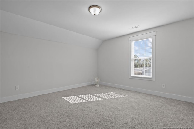 bonus room with vaulted ceiling, carpet, baseboards, and visible vents