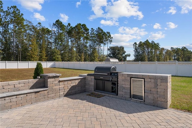 view of patio / terrace with area for grilling and a fenced backyard