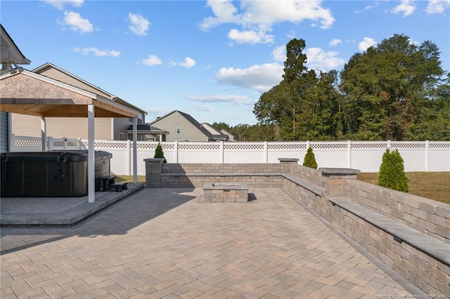 view of patio / terrace with a fenced backyard and a hot tub