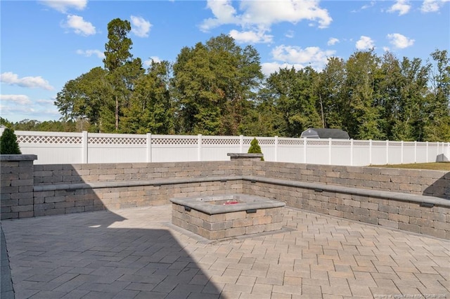 view of patio / terrace featuring an outdoor fire pit and a fenced backyard