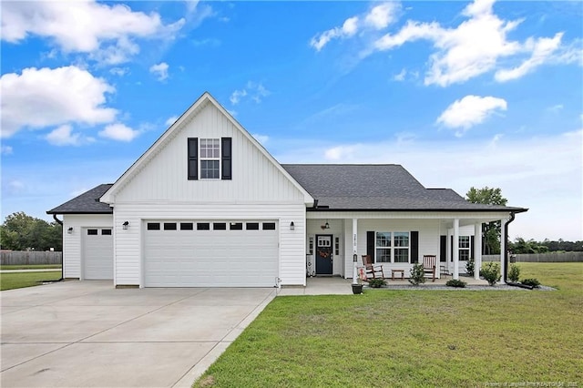 modern farmhouse featuring a front lawn, a porch, board and batten siding, concrete driveway, and roof with shingles