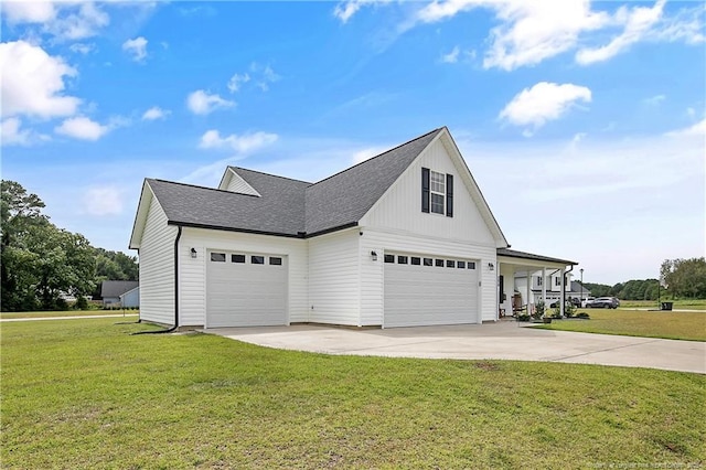 view of side of property with a lawn, driveway, and roof with shingles