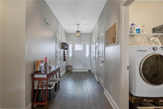 laundry room featuring baseboards, washer / dryer, dark wood-style flooring, and laundry area