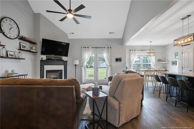 living area featuring visible vents, high vaulted ceiling, a fireplace, ceiling fan, and dark wood-style flooring