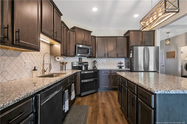 kitchen featuring a sink, light stone counters, dark brown cabinetry, appliances with stainless steel finishes, and dark wood-style flooring