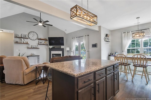 kitchen featuring dark wood-style floors, hanging light fixtures, and dark brown cabinets