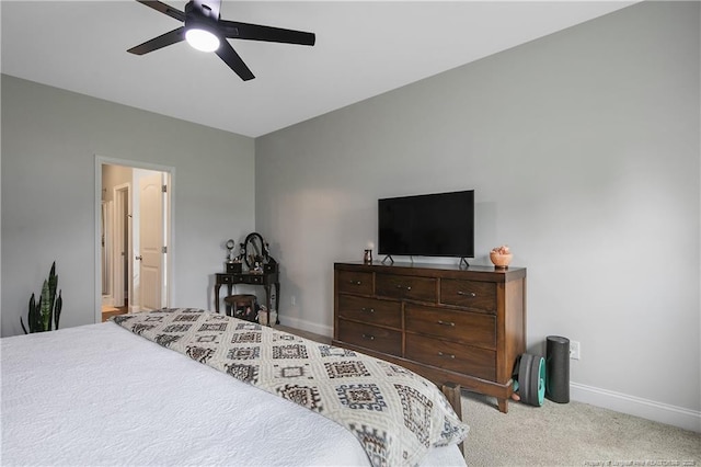 bedroom with ceiling fan, ensuite bathroom, baseboards, and carpet floors