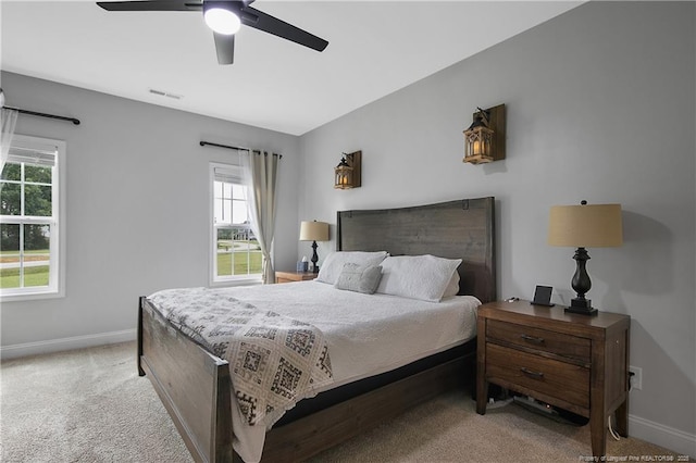 bedroom featuring light carpet, visible vents, ceiling fan, and baseboards