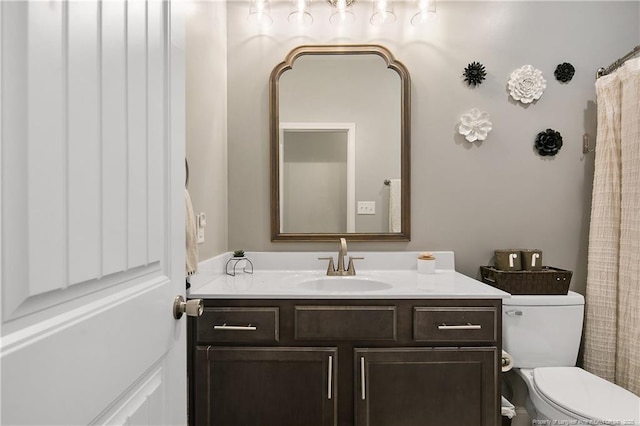 bathroom featuring toilet and vanity