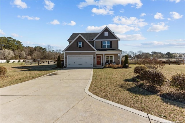 craftsman-style house featuring concrete driveway, a front yard, and fence