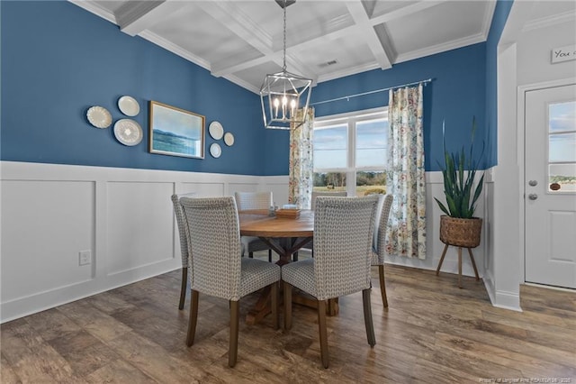 dining room featuring beam ceiling, a healthy amount of sunlight, and wood finished floors