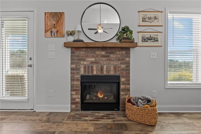 room details with ceiling fan, a fireplace, and baseboards