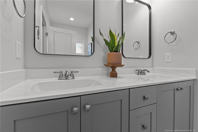 full bathroom featuring double vanity and a sink