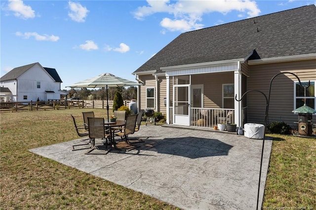 view of patio with fence and a sunroom