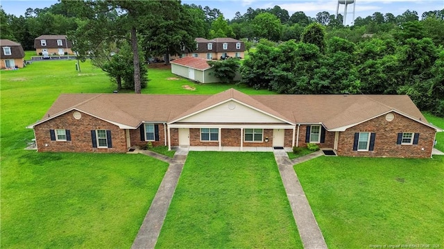 view of front of house with brick siding and a front lawn