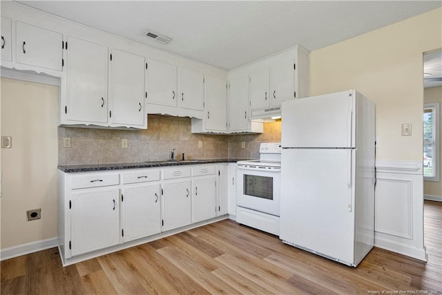 kitchen with white cabinetry, white appliances, visible vents, and under cabinet range hood