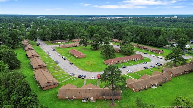 drone / aerial view featuring a wooded view