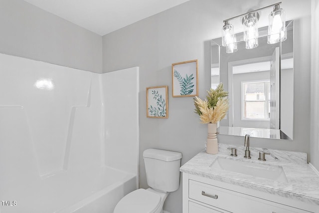 full bath featuring vanity, toilet, and shower / washtub combination