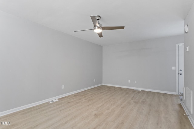 spare room with light wood-style flooring, baseboards, and visible vents