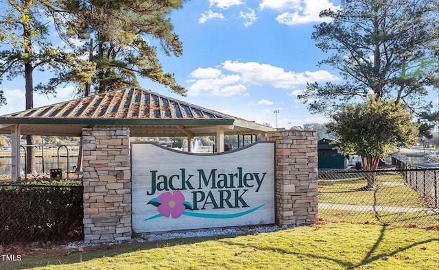 community sign with a lawn and fence