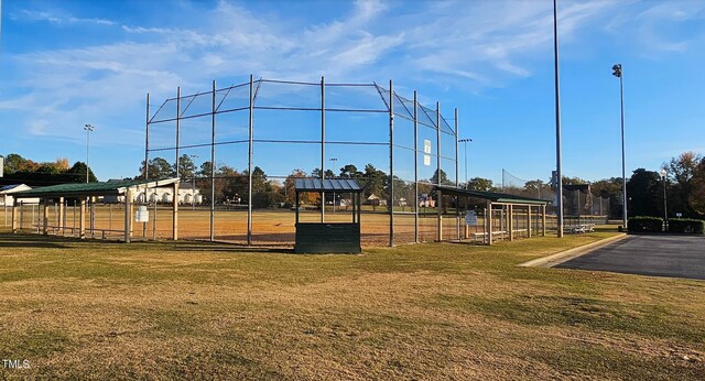 surrounding community with a lawn and fence