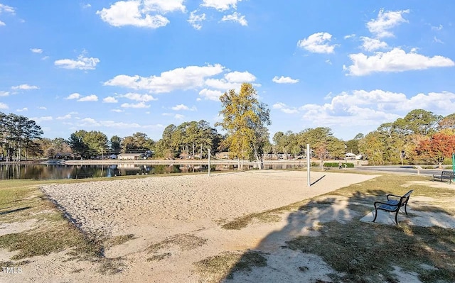 surrounding community featuring a water view and volleyball court