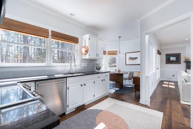 kitchen with a sink, dark countertops, dishwasher, and ornamental molding