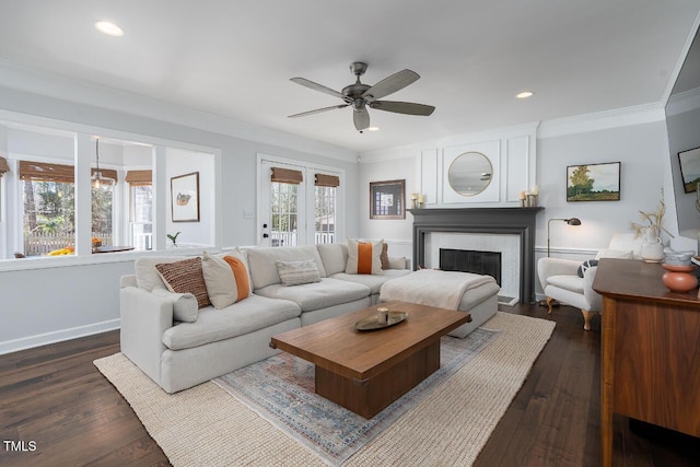 living area featuring ceiling fan, dark wood-style floors, and ornamental molding