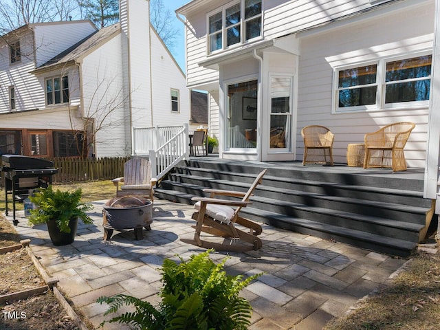 view of patio with fence, area for grilling, and an outdoor fire pit