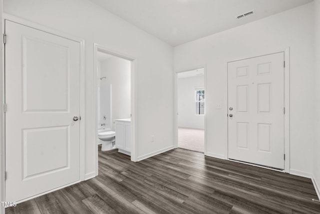 entryway featuring baseboards, visible vents, and dark wood-style flooring