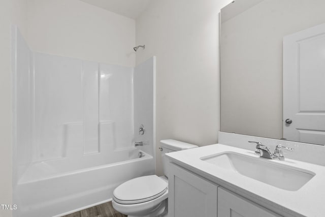 bathroom with vanity, toilet, bathing tub / shower combination, and wood finished floors