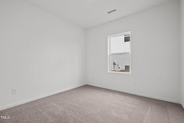 carpeted empty room with baseboards and visible vents