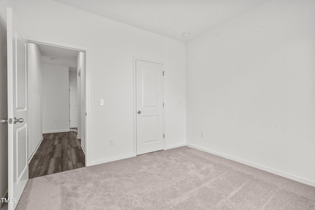 unfurnished bedroom with baseboards and carpet floors