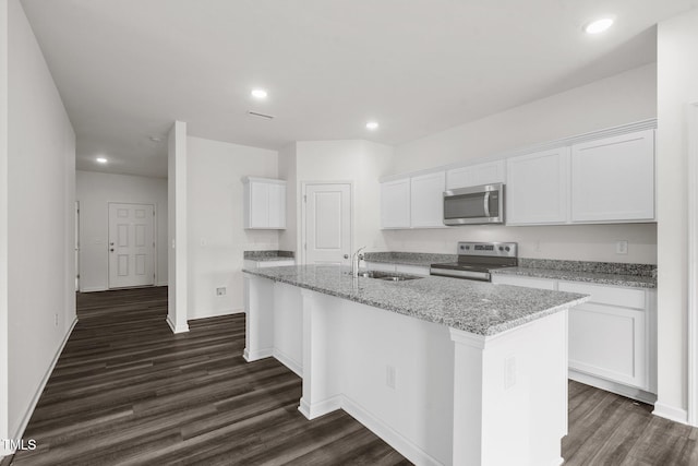 kitchen with dark wood finished floors, white cabinets, appliances with stainless steel finishes, and a sink