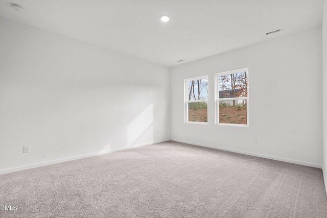 unfurnished room with recessed lighting, carpet, visible vents, and baseboards