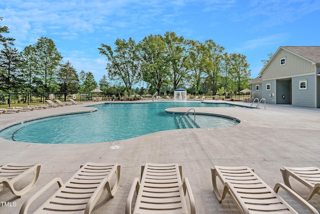 community pool featuring a patio and fence