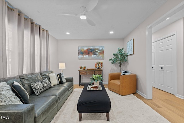 living area with recessed lighting, baseboards, light wood-style floors, and ceiling fan